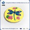 Butterfly metal diacast pin badge in yellow background.